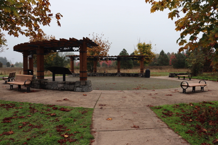 Gateway Plaza on hard surface &ndash; short stone walls &ndash; benches, garbage can and informational display