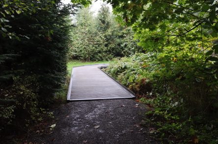 Crushed rock Coyote Way Trail transitions to a metal boardwalk