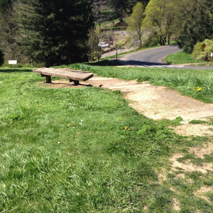 Access route to bench off the Overlook Trail may have grass growing over the natural trail surface Access route to bench off the Overlook Trail may have grass growing over the natural trail surface