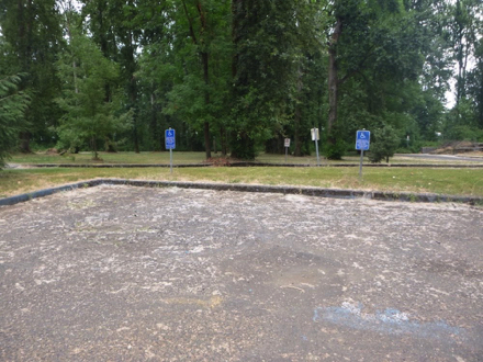 Furthest parking lot from the entrance - hard surface - accessible parking spaces - spaces are not maintained