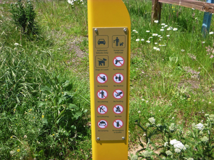 Sign post indicating park rules Sign post indicating park rules