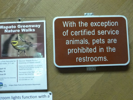 Sign that pets are prohibited in restrooms, except service animals Sign that pets are prohibited in restrooms, except service animals